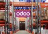 The Future of Manufacturing: How Odoo Is Leading the Way Workers using Odoo’s Manufacturing Module on a tablet to manage production and inventory in a modern factory setting