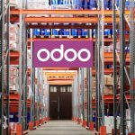 The Future of Manufacturing: How Odoo Is Leading the Way Workers using Odoo’s Manufacturing Module on a tablet to manage production and inventory in a modern factory setting