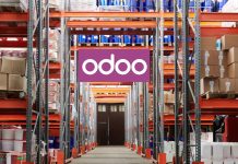 The Future of Manufacturing: How Odoo Is Leading the Way Workers using Odoo’s Manufacturing Module on a tablet to manage production and inventory in a modern factory setting
