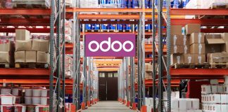 The Future of Manufacturing: How Odoo Is Leading the Way Workers using Odoo’s Manufacturing Module on a tablet to manage production and inventory in a modern factory setting