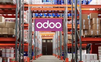 The Future of Manufacturing: How Odoo Is Leading the Way Workers using Odoo’s Manufacturing Module on a tablet to manage production and inventory in a modern factory setting