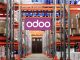 The Future of Manufacturing: How Odoo Is Leading the Way Workers using Odoo’s Manufacturing Module on a tablet to manage production and inventory in a modern factory setting