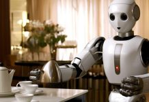 Tesla’s Robot Can Now Do Household Chores — Elon Musk Calls It the “Biggest Product Ever” “Tesla’s Optimus humanoid robot folding clothes in a home setting during a demonstration of real-life chores.”