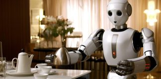 Tesla’s Robot Can Now Do Household Chores — Elon Musk Calls It the “Biggest Product Ever” “Tesla’s Optimus humanoid robot folding clothes in a home setting during a demonstration of real-life chores.”