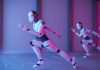 China’s Robot Startups Are Racing Ahead: How Innovation and Speed Are Changing the Game “Modern humanoid robot developed by a Chinese startup walking in a tech expo, surrounded by a crowd”