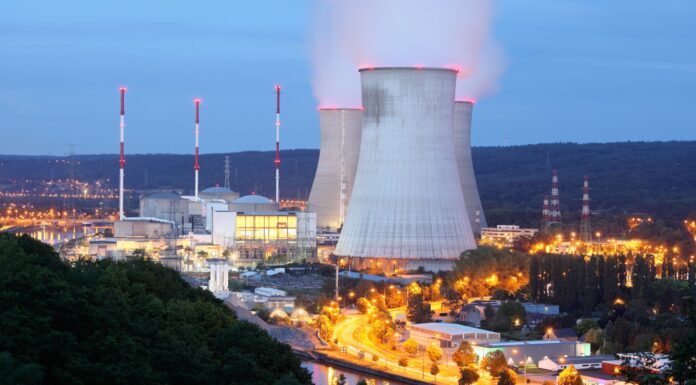 Nuclear-Powered AI? Big Tech Wants It Here’s the Full Story "A glowing AI brain connected to a nuclear reactor symbol, representing the future of artificial intelligence powered by atomic energy."